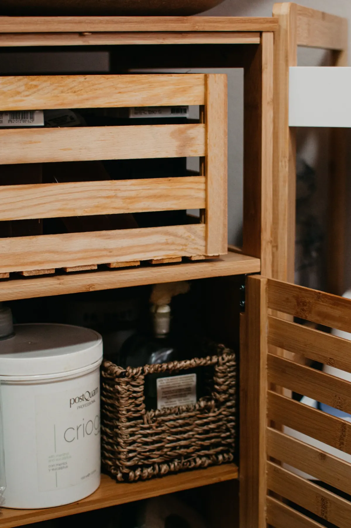 Meuble en bois de l’espace de soins, avec des produits professionnels et un panier tressé